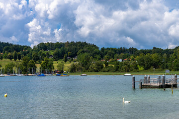 Idyllic panorama view of Tegernsee lake on a sunny summer day with blue sky cloud, Bavaria, Germany
