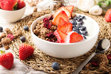 Muesli with organic berries and nuts. Oat muesli with raspberry, blueberry, strawberries, almond, cashew, banana. Healthy food, top view