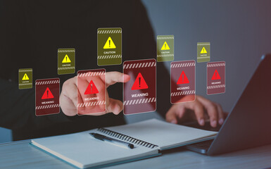 Businessman using laptop with spam virus with warning to alert internet security and data breach or...