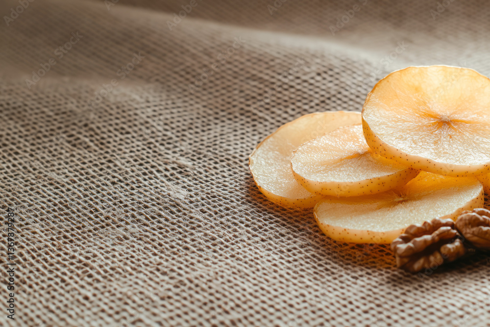 Poster Rustic composition featuring dried apple slices and walnuts placed artistically on a burlap