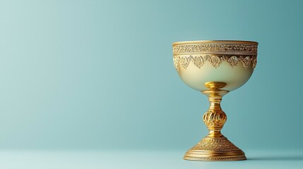Ornate gold chalice on teal background
