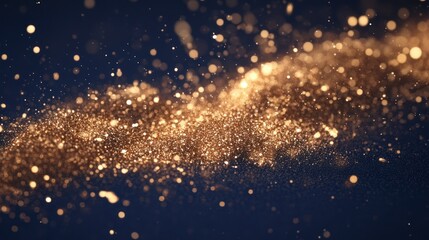 Abstract background of gold particles and bokeh on dark blue background.
