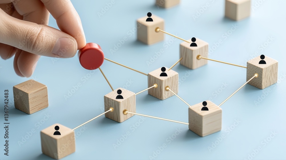Poster wooden blocks connected by strings, illustrating teamwork and networking, hand placing a red piece.