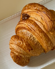 Golden Croissant Freshly Baked on a White Plate