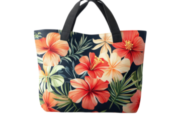 A vibrant hibiscus floral tote bag, perfect for a tropical getaway or a summer day out, features bold red and orange blooms on a dark navy background with lush green leaves.
