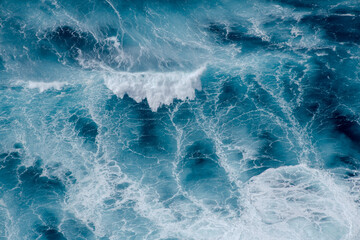 Huge crushing waves seen from above creating amazing textures.	