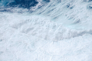 Huge crushing waves seen from above creating amazing textures.	