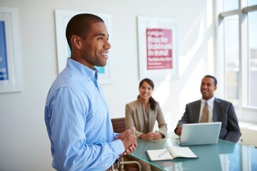 African male leading business meeting in modern office with colleagues