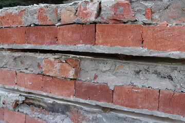 Construction, repair, dismantling of an old brick wall. Concrete, sand building material.