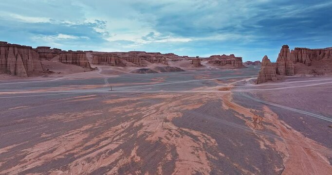Aerial view of yardang geological formations in vast desert under a dramatic sky. Famous Dahaidao no man's land natural scenery in Xinjiang, China.