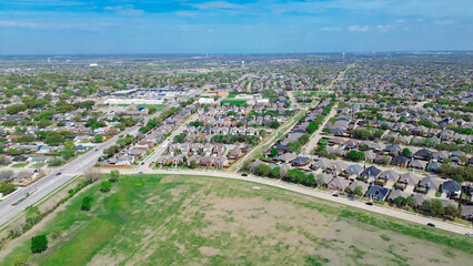 Vacant land near Worley and Memorial Drive fast growing suburban residential neighborhood in The Colony, Denton County, Texas, row of single-family houses in flat area by Lewisville Lake, aerial