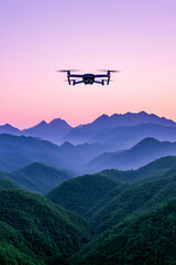 Drone flying over misty mountains at sunset