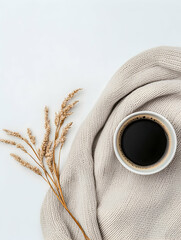 Cozy autumn scene coffee cup on knitwear with dried flowers