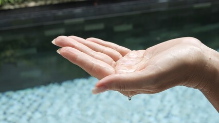 Refreshing skin care moment Woman applies refreshing moisturizing gel to her hand Refreshing gel enhances skins softness radiance and hydration Self-care ritual with refreshing effect for smooth skin