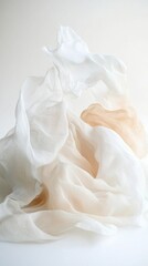 A crisp, white cloth is elegantly spread out on the ground, its smooth texture catching the soft sunlight, creating a serene and inviting atmosphere in the surrounding natural setting.