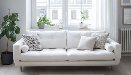 Obraz premium Modern White Sofa with Cushions in a Bright Living Room near Window Stylish Home Interior Design