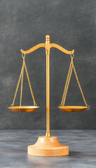 Golden scales of justice on dark background