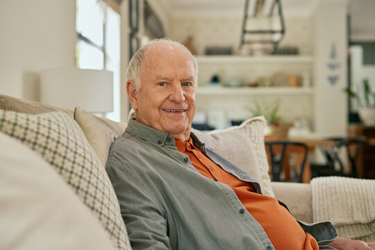 Portrait of elderly man relaxing on sofa