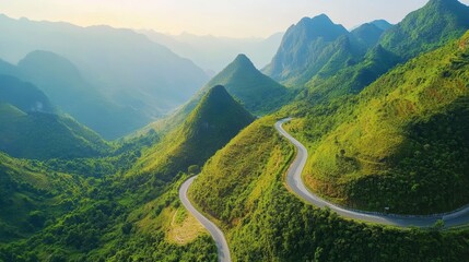 Winding mountain road through lush green hills and valleys.