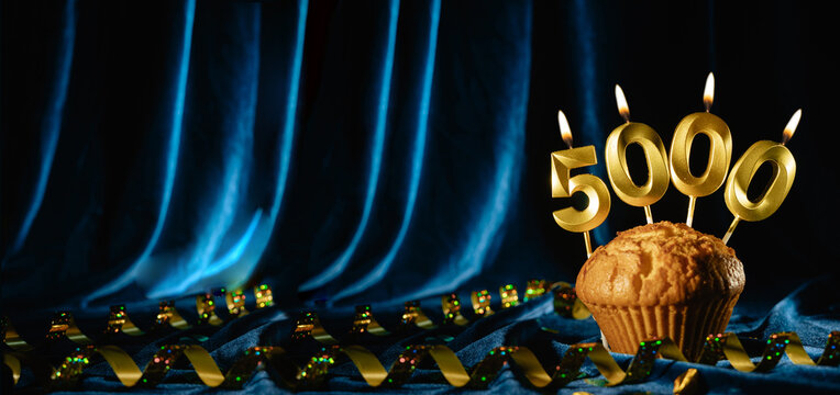 5000 followers card. for social networks and blogs. Festive cupcake with candles number five thousand on blue velvet background. followers card. 5000 online community fans and subscriber.