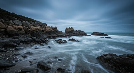Serene coastal landscape at dusk with rocky formations and gentle waves