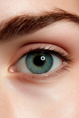 Obraz premium Close-up of a human eye in vivid green and blue, highlighting intricate details