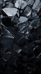 A striking black and white background featuring shards of broken glass scattered across the surface, reflecting light and creating intriguing patterns and textures.