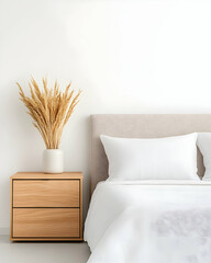 Minimalist bedroom with light beige bedding, wooden nightstand, and dried pampas grass