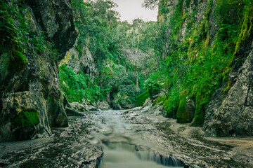 Mountain gorge with caves and little river from the portuguese touristic site of Olhos de Agua - Alviela - Alcanena