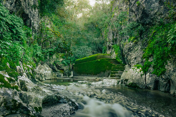 Mountain gorge with caves and little river from the portuguese touristic site of Olhos de Agua - Alviela - Alcanena
