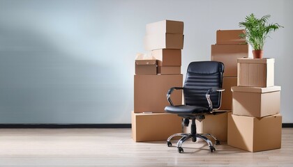 stack of cardboard boxes with stuff and office chair in empty office room moving to new office relocating crisis remote working start new business e commerce concept