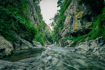 Mountain gorge with caves and little river from the portuguese touristic site of Olhos de Agua - Alviela - Alcanena
