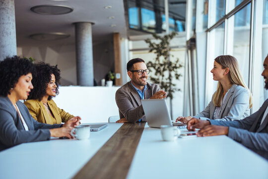 Group of Professionals Engaged in a Collaborative Business Meeting in Modern Office