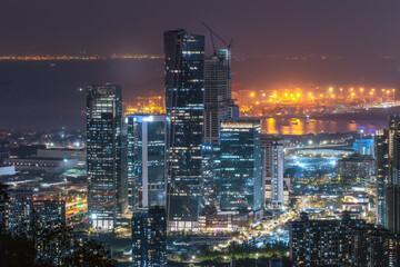 Vibrant Nightscape of a Modern City Skyline with Illuminated Buildings