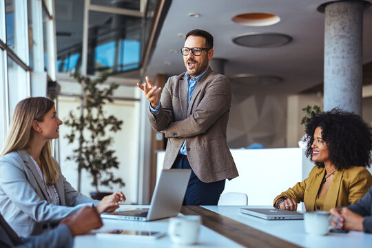 Business Meeting with Enthusiastic Presenter in a Modern Workplace Environment