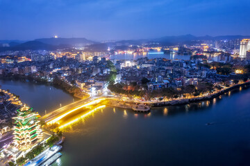 A Stunning Aerial View of a City at Night with Vibrant Lights and Scenic Waterways