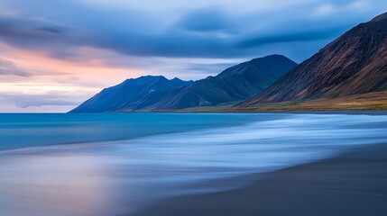 Serene Coastal Landscape at Dusk with Mountains and Gentle Waves Under a Colorful Sky