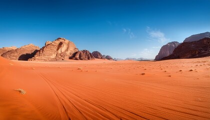 Fototapeta premium wadi rum s vibrant red sands with clear blue sky a captivating landscape showcasing the unique desert terrain and striking color contrast
