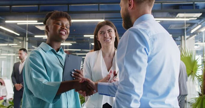 Young african american business woman, HR manager handshakes company position candidate, entrepreneurs, broker, client shake hand to start business meeting in office, after job interview acquaintance