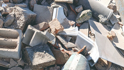 Construction debris and rubbles stock on a waste disposal site for recycling. Close up. Selective waste sorting and population environmental responsibility concept.