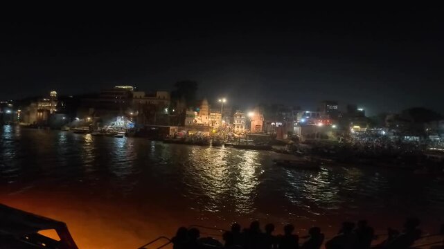 video clip of river cruise on Ganga river through the ghats of Varanasi in India during evening time