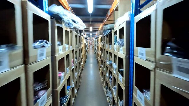 Shelves and boxes of merchandise in a wholesale clothing warehouse. Wholesale clothing warehouse, view from inside. Fashion clothing warehouse. Smart warehouse concept.