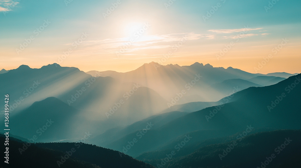 Poster mountain range with sun rays shining through the fog creating a scenic view at dawn or dusk time