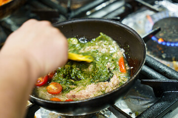Mixing Pesto and Ingredients in Pan