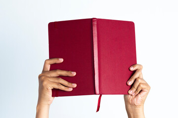 The hands of people hold books. woman's hand holding notebook on white isolated background.	