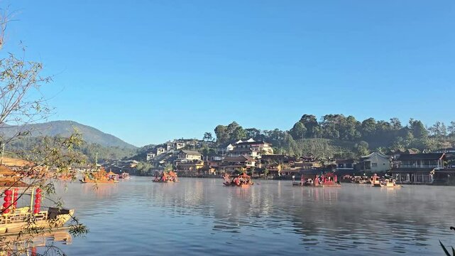 Morning atmosphere of Lee wine Ruk Thai, Ban Rak Thai a Chinese settlement, a popular tourist attraction. Tourists take antique wooden boat to see lake. January21, 2025 Mae Hong Son province,Thailand.