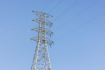 Powerline tower with clear blue sky background