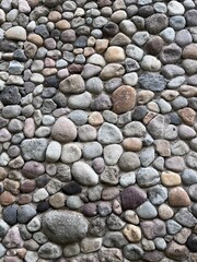 Natural Stone Wall Texture with Multi-Color Pebbles for Backgrounds and Design 