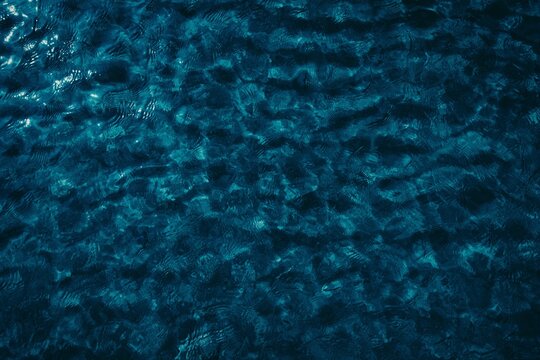 small ripples on dark blue water in the sea