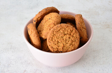 A bowl of delicious and freshly baked oatmeal cookies